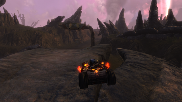 View the full-size Brütal Legend gameplay screenshot showing the Deuce driving through the metal landscape